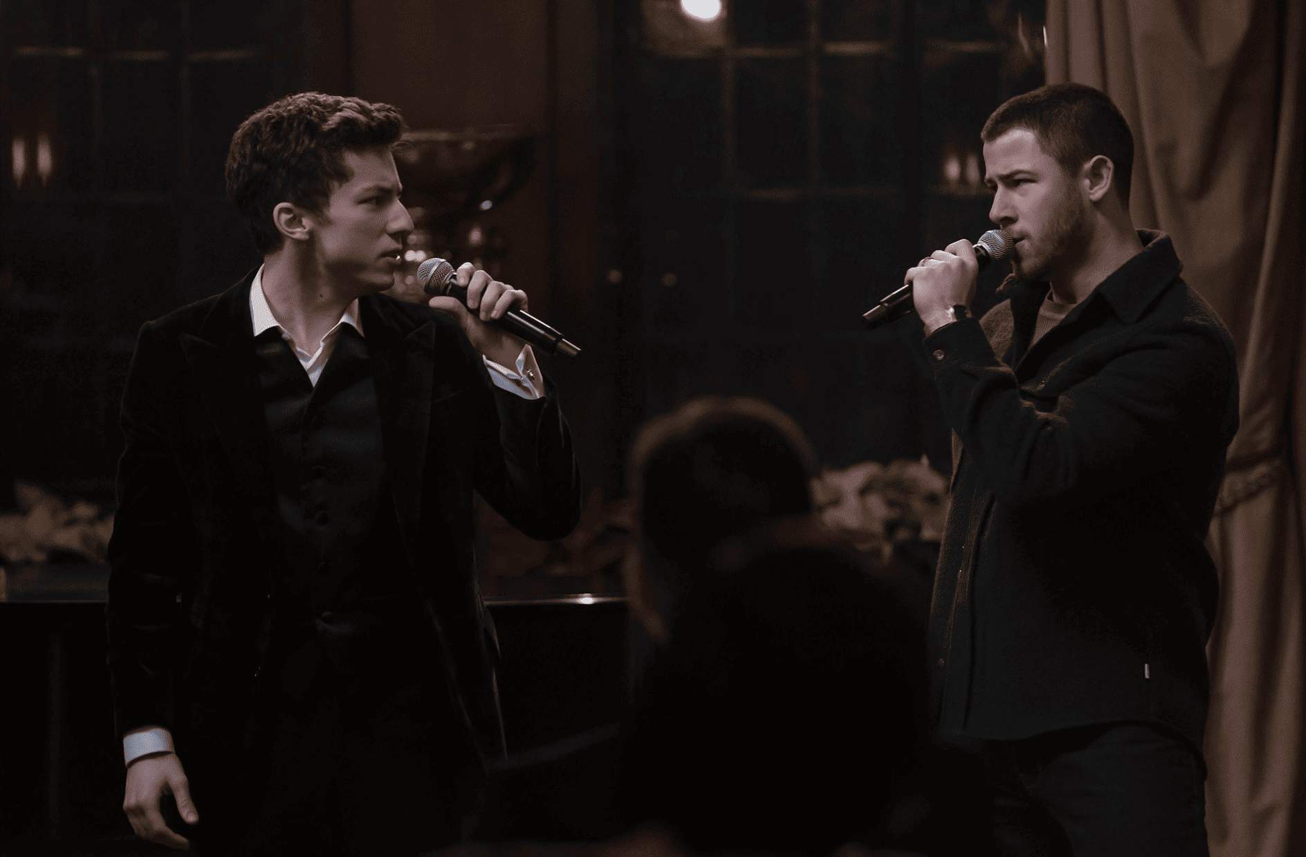 Scène intense du duel vocal entre Nick Jonas et Andrew Barth Feldman dans A Very Jonas Christmas Movie
